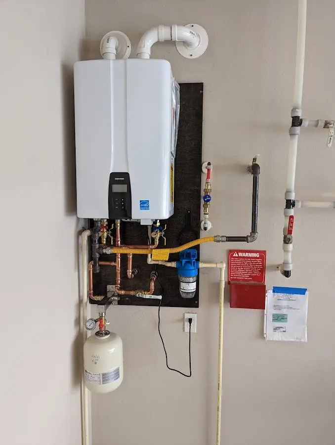 Professional plumber installing copper piping in a Webster Groves home